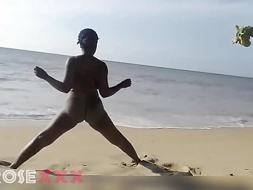 Ebony doll doing some exercise bare on the beach