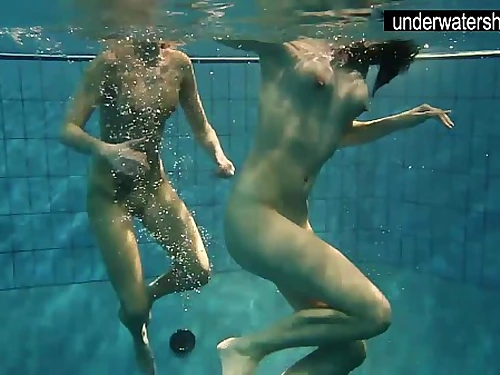 Two sexy amateurs showing their figures off under water